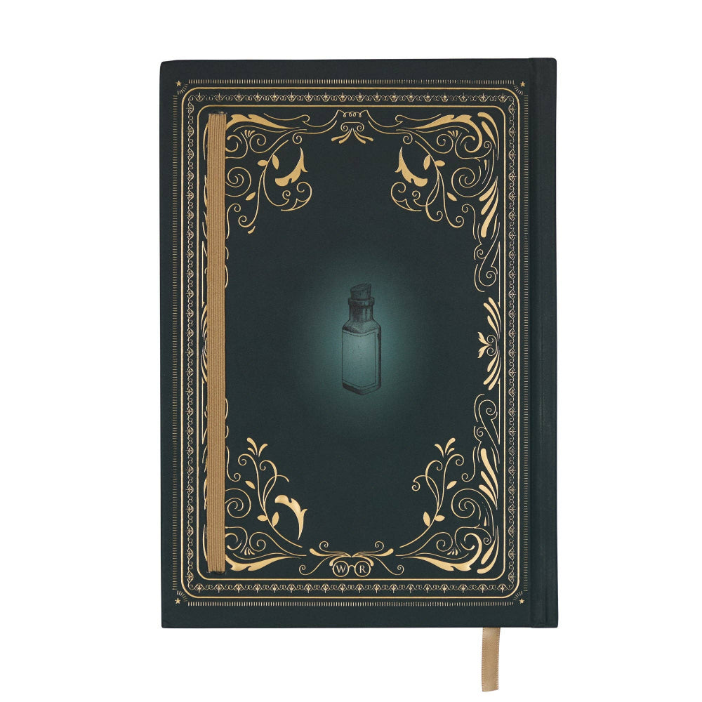 Decorative notebook with gold embellishments and a small bottle illustration on a white background