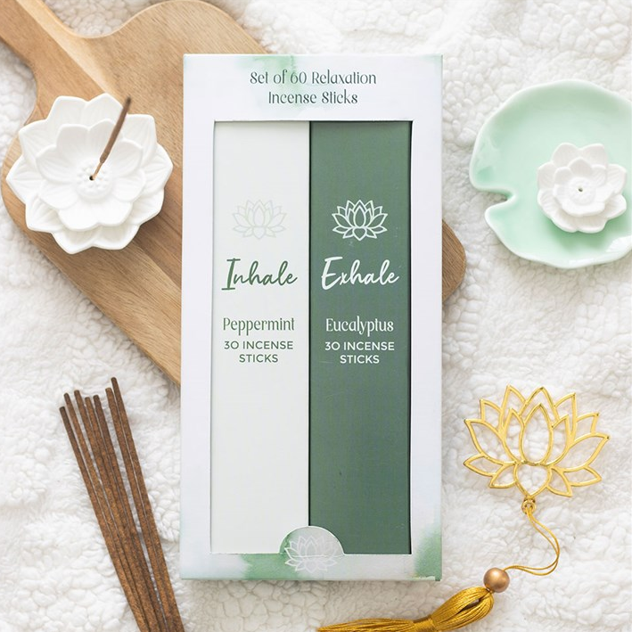 Set of incense sticks with packaging on a textured surface