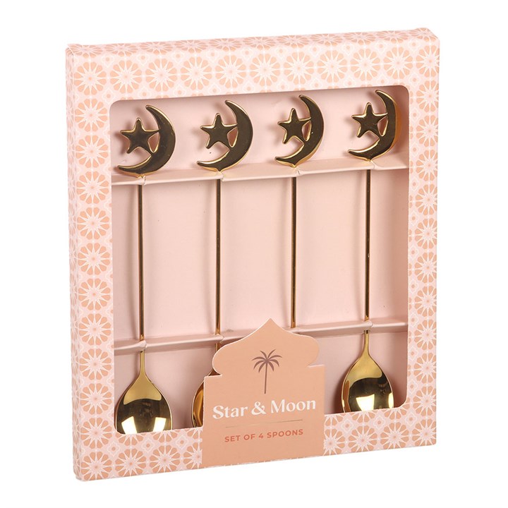 Set of four gold spoons with star and moon designs in a decorative box.