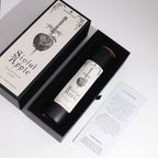 Candle labeled 'Sinful Apple' in a decorative box with a white background