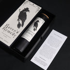 Candle packaging with 'Raven's Remedy' branding on a dark background