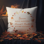 Decorative pillow with autumn-themed design and text on a soft surface.