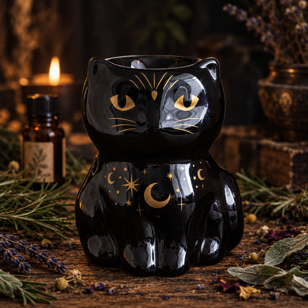 Black cat-shaped ceramic oil burner with gold accents on a dark surface.