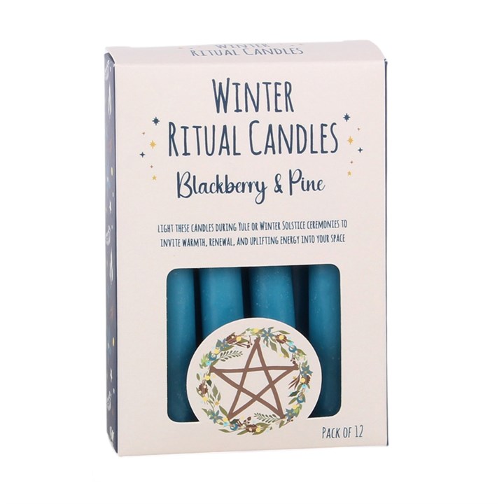 Winter Ritual Candles Blackberry & Pine scent in a light pink box with a clear window showing blue teal candles inside, and a circular star of David wreath illustration on the front.