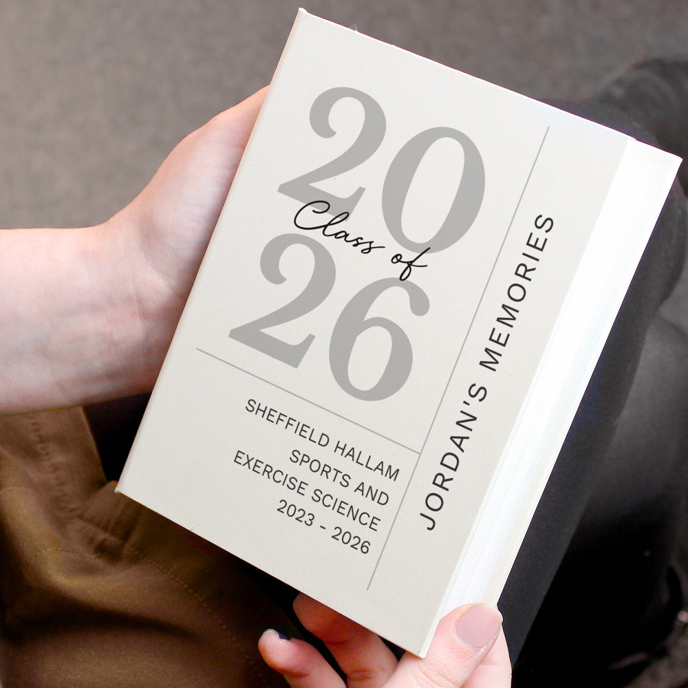 Book titled '2026 Class of 2026Jordan's Memories' held by a person.