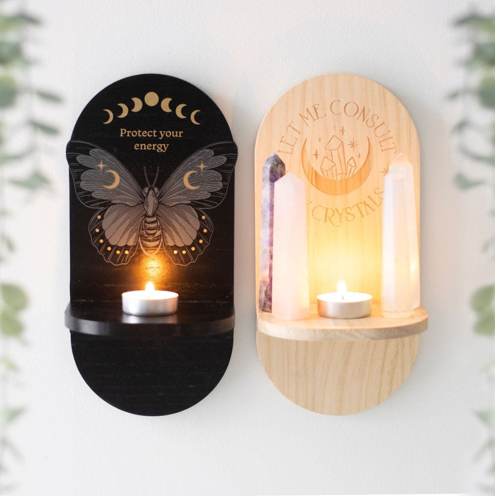 Two wall-mounted candle holders with decorative designs and text on a white background.