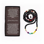 Necklace with colored beads next to a descriptive card on a white background