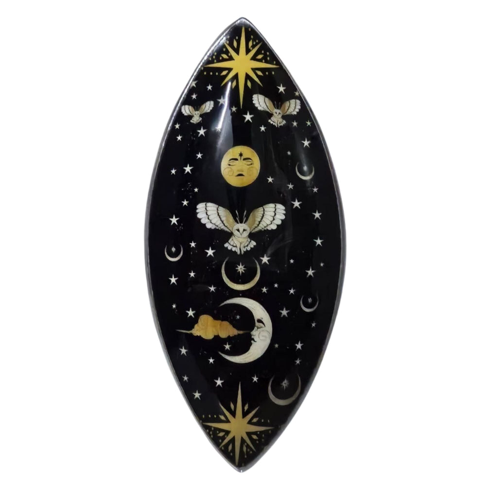Decorative plate with celestial design featuring moons, stars, and birds on a black background.