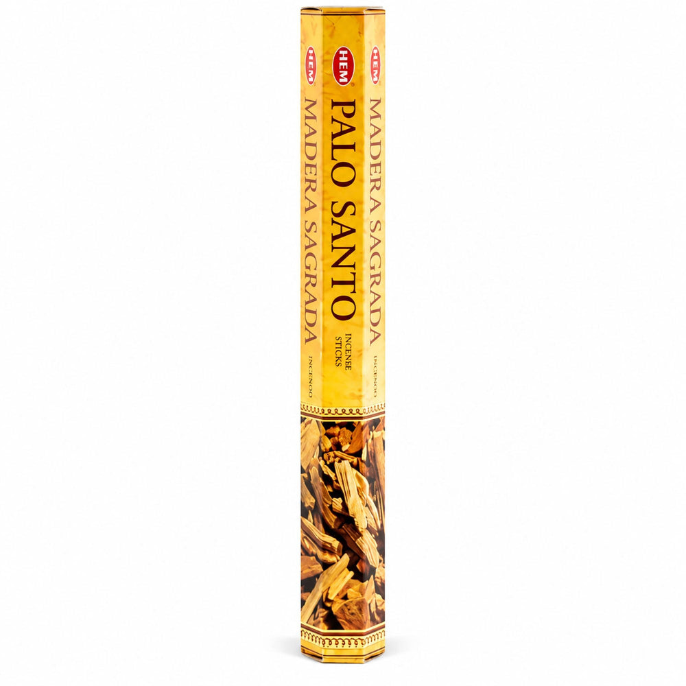 A single tall cylindrical incense stick package labeled 'PALO SANTO' and 'MADERA SACRADA' in Spanish, with a yellow-gold wrapper and a photo of dried wood pieces near the bottom, shown on a plain white background.