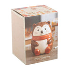 Ceramic oil burner shaped like a hedgehog in a box with a fall-themed design.