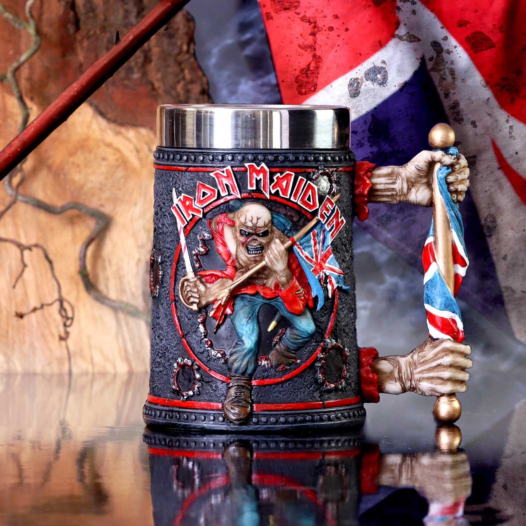 Iron Maiden-themed mug with band logo and British flag design, placed against a textured background.