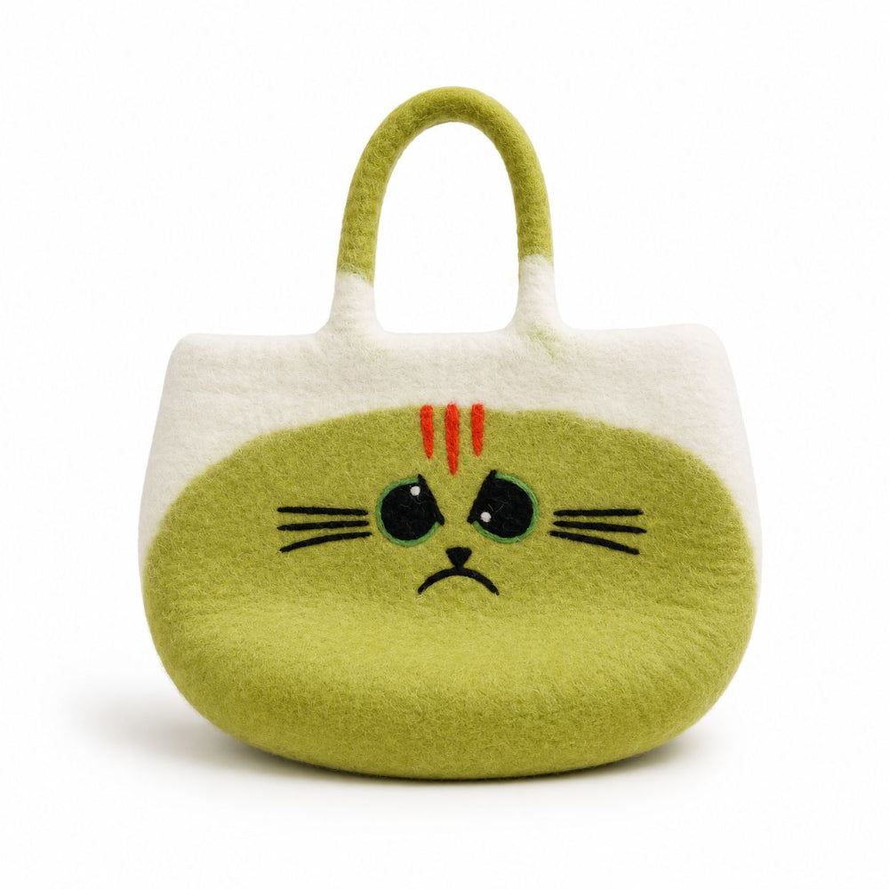 A cute, soft felt cat-shaped handbag in light green and white, featuring a sad face with red whiskers and black embroidered eyes and whiskers.