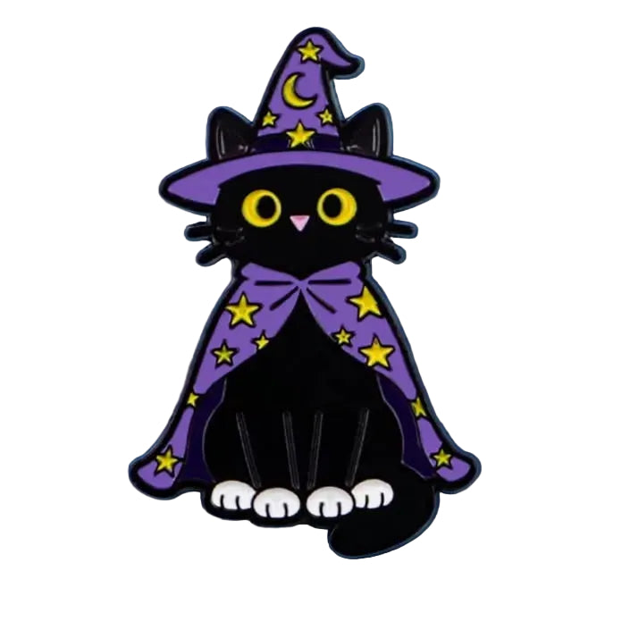 A black cat enamel pin dressed as a witch, featuring a purple hat and cape with yellow stars, set against a solid light blue background.