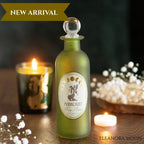An olive green frosted glass apothecary-style bottle with a clear round stopper, labeled 'MOONLIGHT Sleep Powder,' displayed on a wooden surface with lit candles and white flowers in the background. A banner at the top reads 'NEW ARRIVAL' and 'ELEANORA MOON' appears at the bottom right.