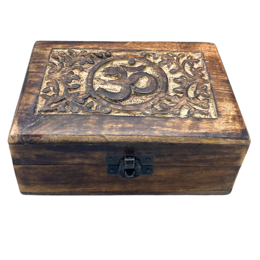 Wooden box with Om symbol and floral patterns on a white background