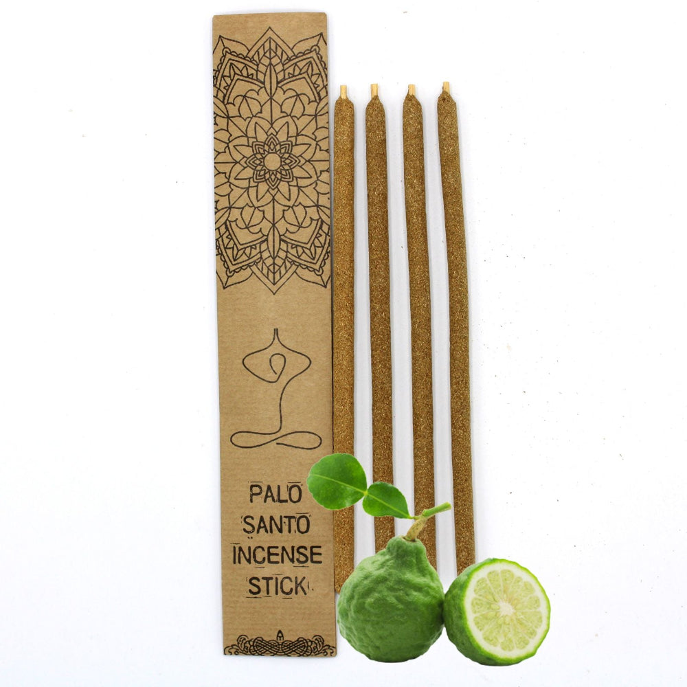 Palo Santo incense sticks with packaging and lime on a white background