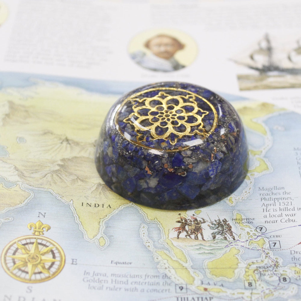 Decorative stone with gold intricate design on a map background
