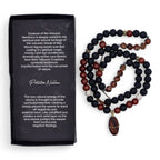 Beaded necklace with dark and red beads next to a black box with text on a white background