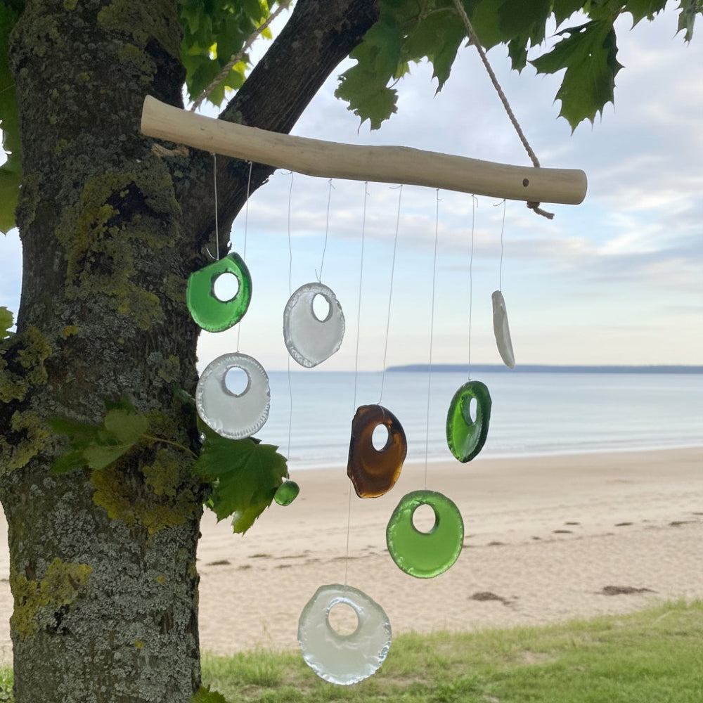 Decorative hanging mobile with circular shapes on a tree branch