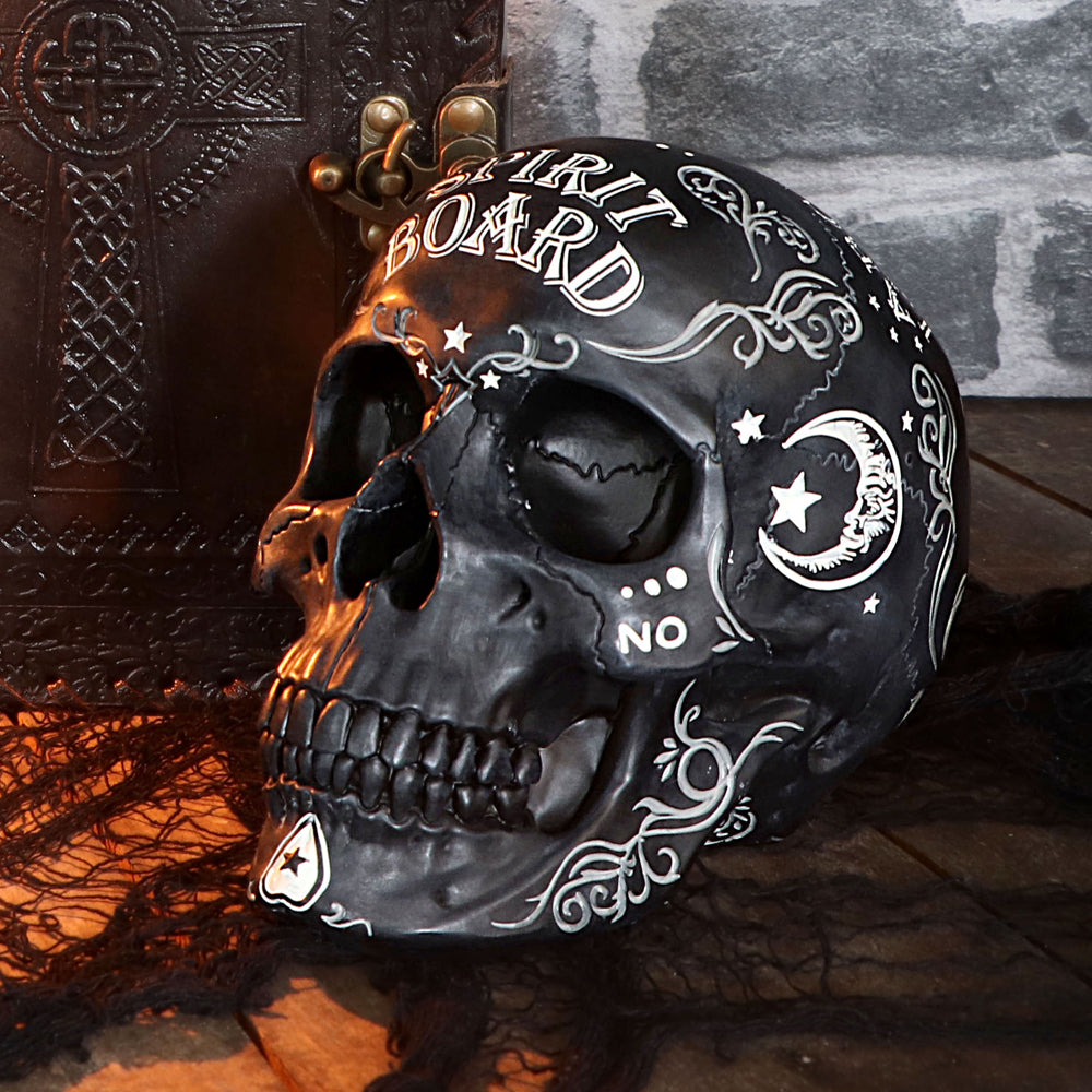 Decorative skull with intricate designs and 'Spirit Board' text, set against a dark background.  Part of our skull collection at Eleanora Moon