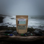 Bag of tea tree and lime Himalayan salt on a wooden surface with a plant in the background