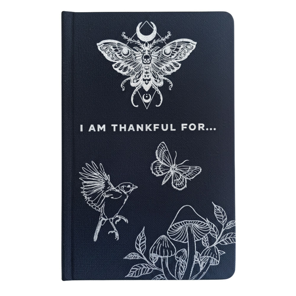 Black notebook with a nature-themed design and the wording I am thankful for.