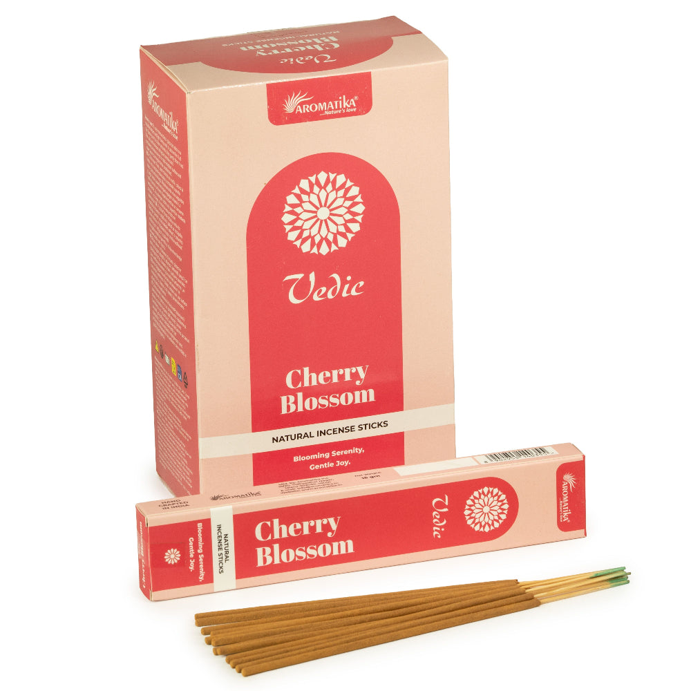 A box of Aromatics Vedic Cherry Blossom incense sticks, with a matching incense stick box and several natural wood incense sticks displayed in front on a white background.