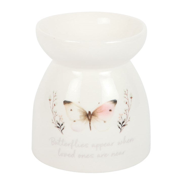 White ceramic oil burner with butterfly design on a white background