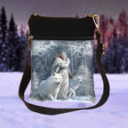 Crossbody bag with a winter scene print featuring a woman and white wolves.