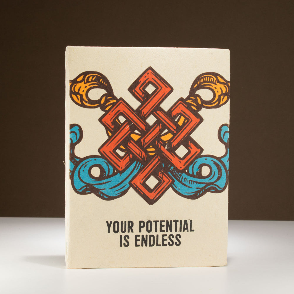 Notebook with colorful design and 'Your Potential is Endless' text on a brown background