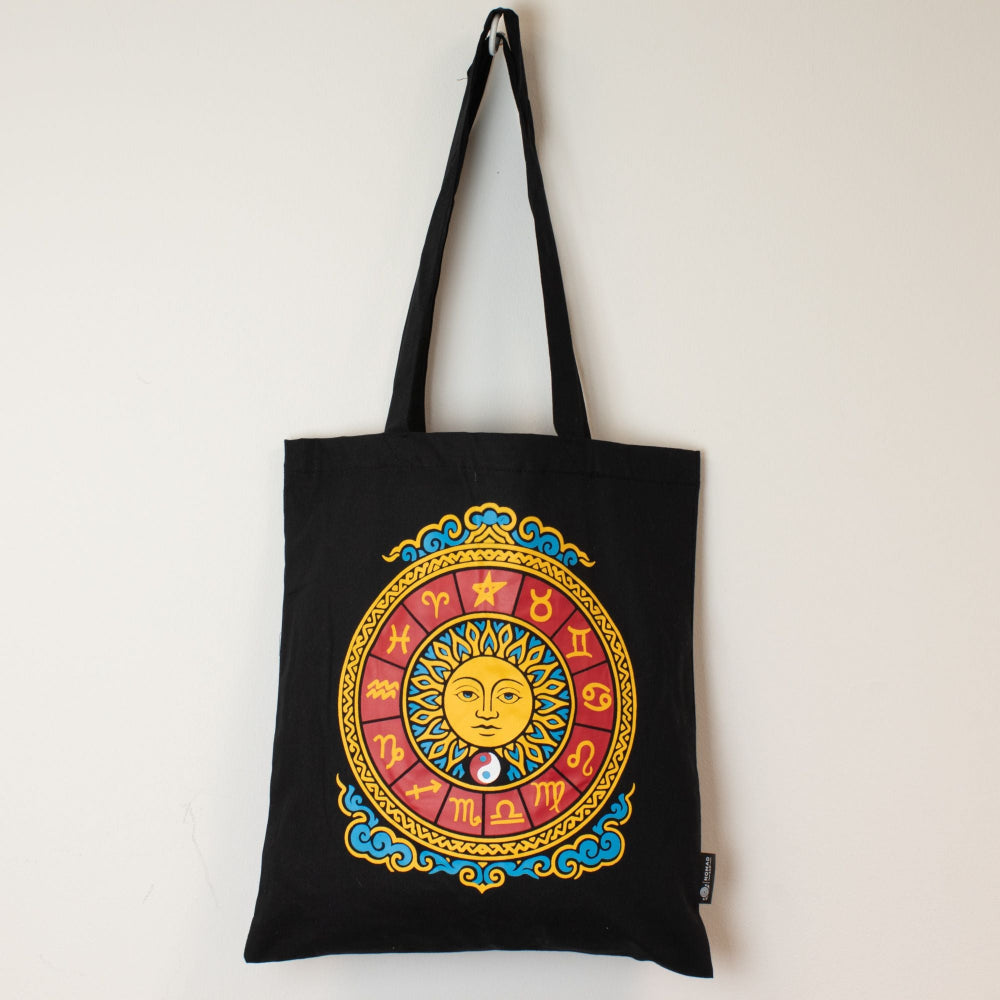 Black tote bag with colorful zodiac design on a white background