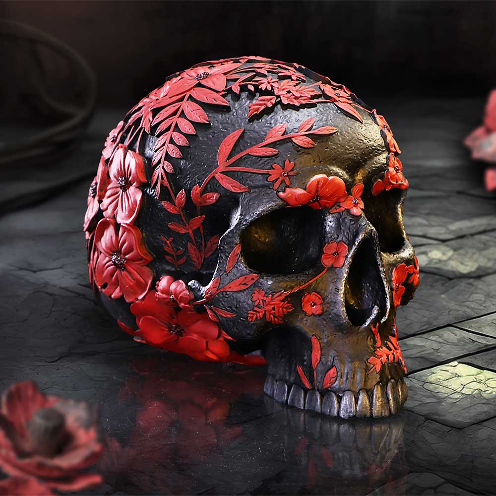 Age of Opium skull by Nemesis Now, black with embossed red poppies and leaf detailing.