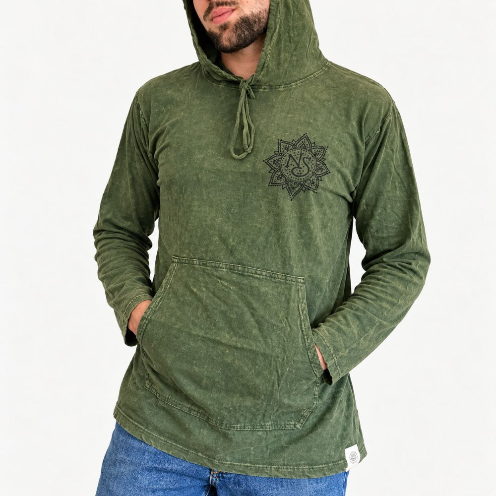 A man wearing a washed olive green hooded sweatshirt with a black mandala-style chest graphic and drawstrings, paired with blue jeans, against a plain white background.