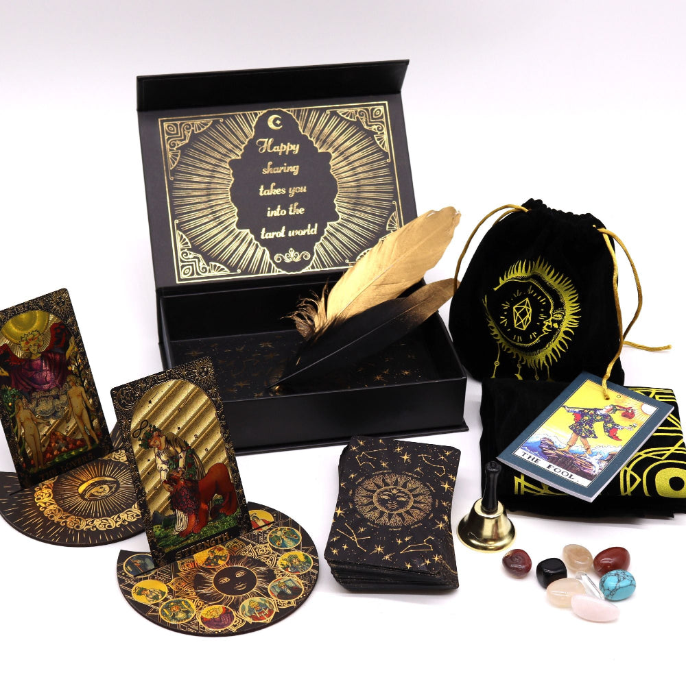 Collection of tarot cards, a deck, a box, and other accessories on a white background