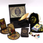 Collection of tarot cards, a deck, a box, and other accessories on a white background