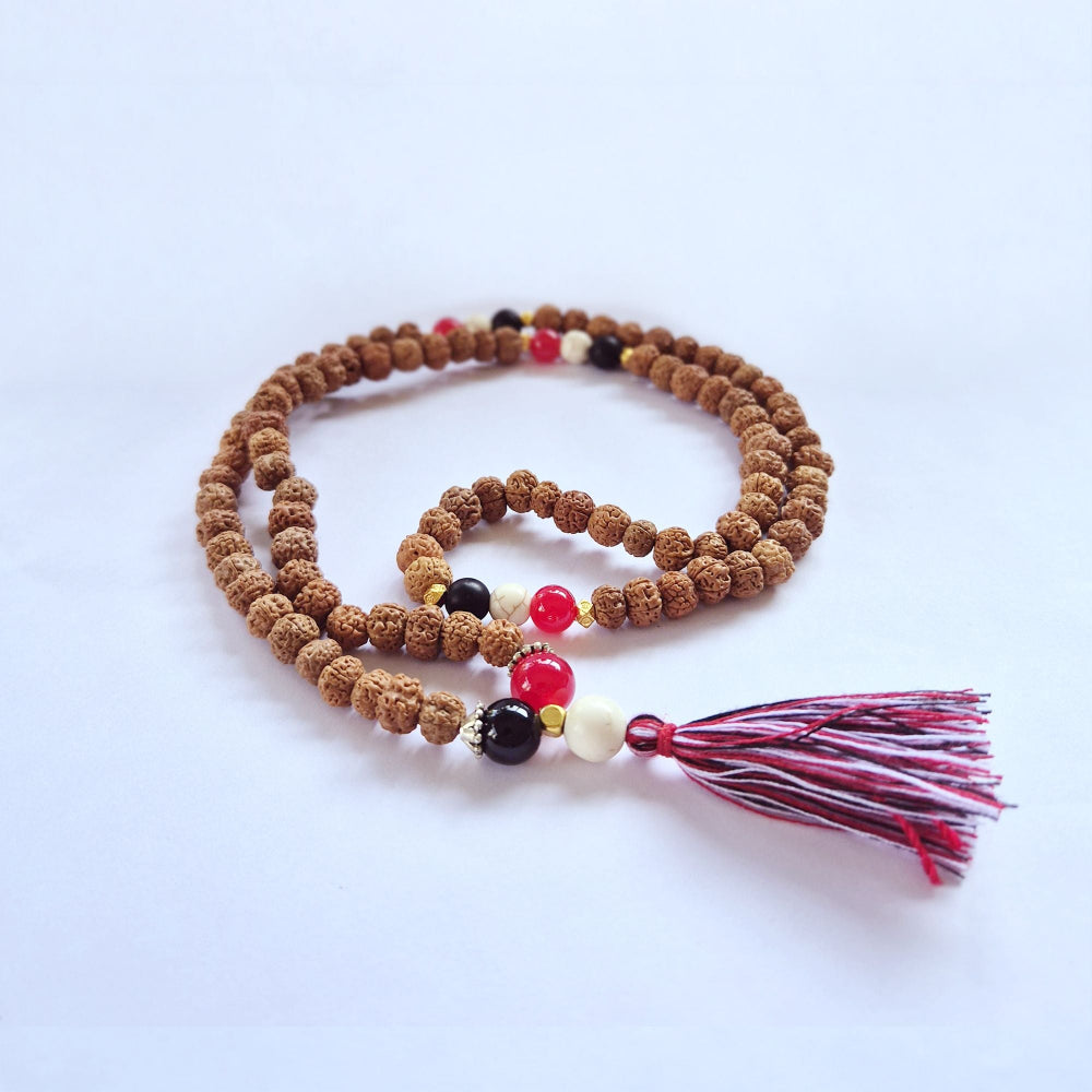 Brown beaded necklace with colorful beads and a tassel on a white background