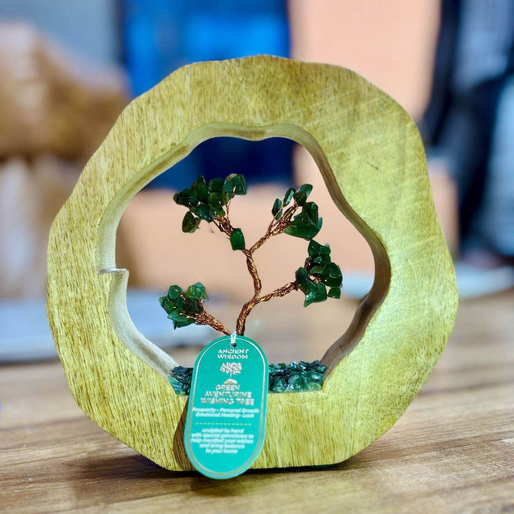 Decorative item with a tree design inside a wooden frame on a table.