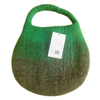 Green handbag with a gradient effect and a visible tag on a white background