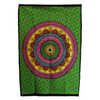 Colorful mandala tapestry on a green background