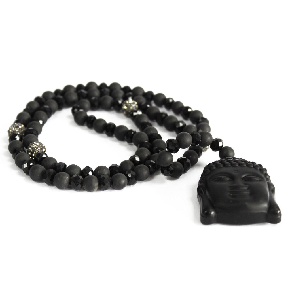 Black beaded necklace with a Buddha head pendant on a white background