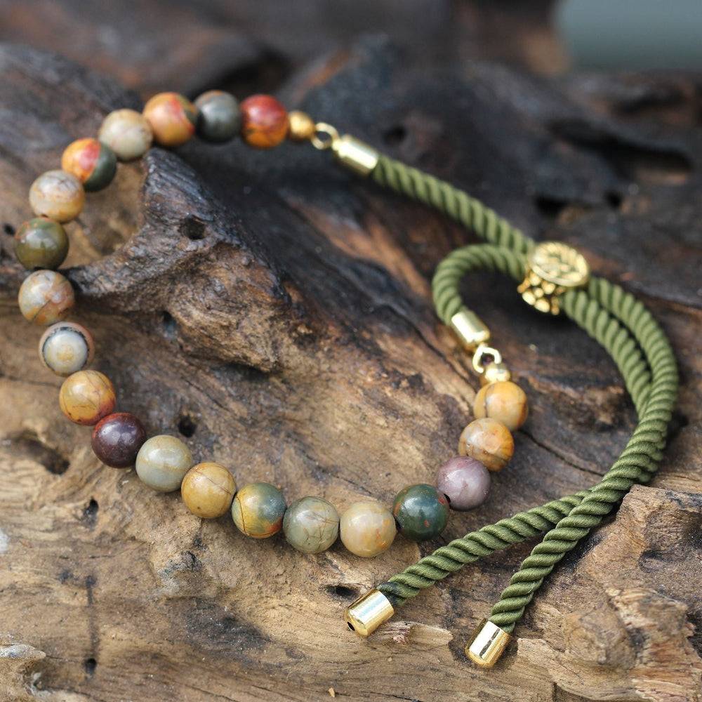bracelet with beaded and braided design on a wooden surface