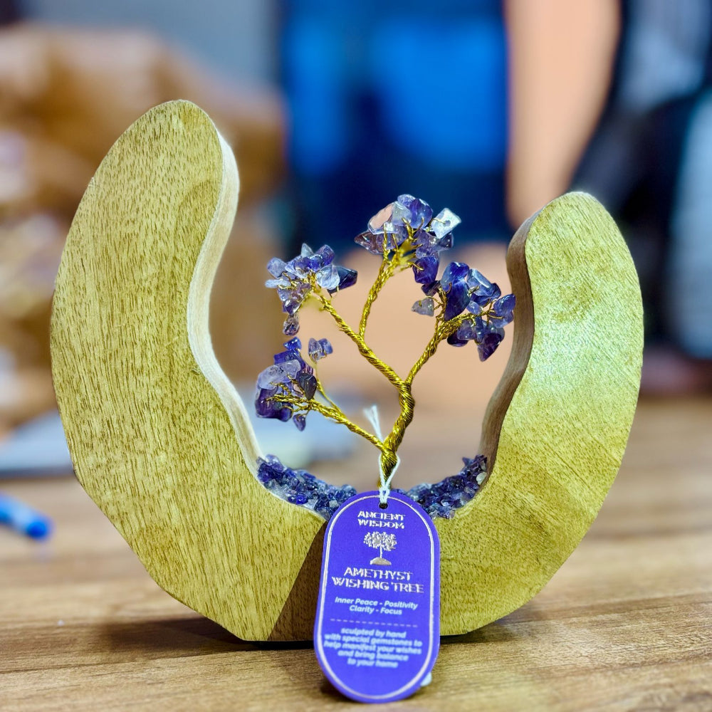Wooden sculpture with a tree made of crystals on a wooden surface
