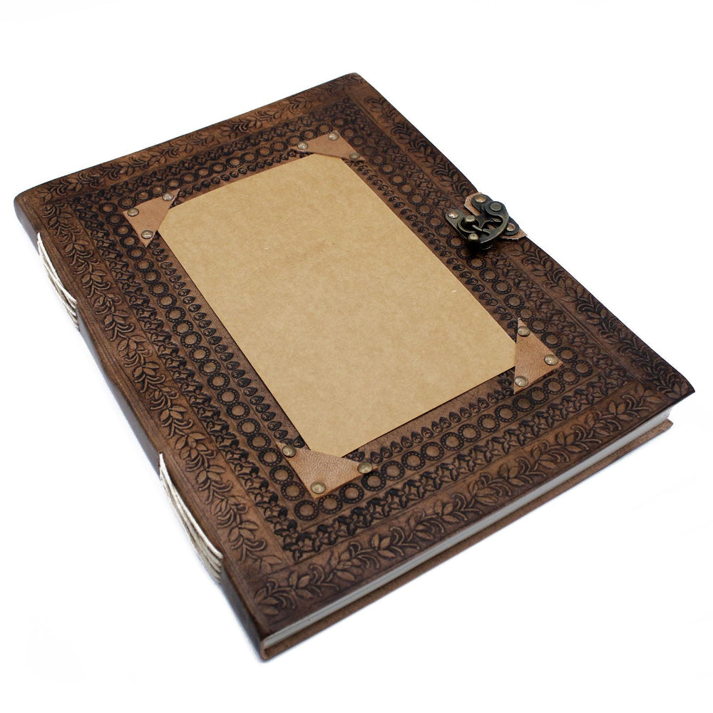 Decorative leather-bound notebook with embossed design on a white background
