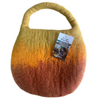 Wool bag with gradient color pattern and product tag on a white background