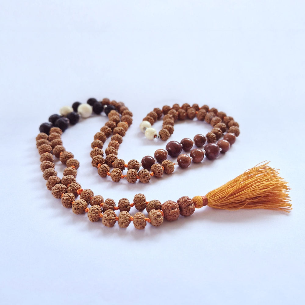 Meditation mala necklace with tassel on a light blue background