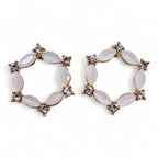Pair of gold and white hoop earrings on a white background