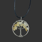 Tree of Life pendant with stones on a black cord against a white background