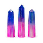 Three crystal points with a gradient of blue to pink on a white background