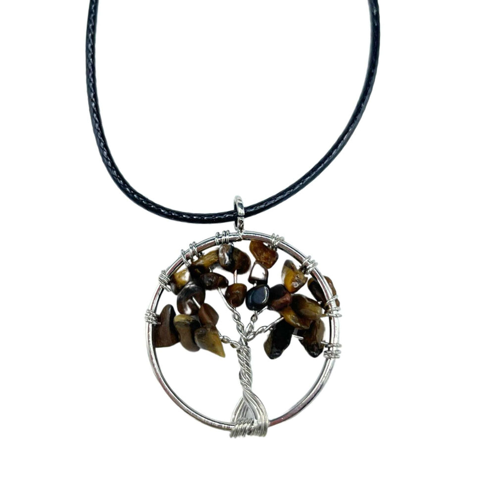 Tree-shaped pendant with stones on a black cord against a white background