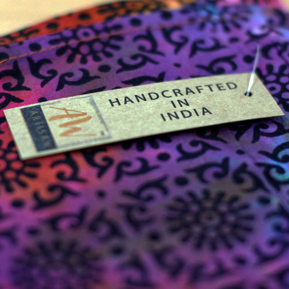 Handcrafted in India label on a colorful fabric background